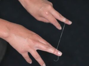 flossing step 1 - Wrap the floss around your middle finger on both hands so you don’t need to grip it.
